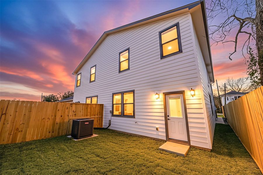 Private, fenced backyard with rear entry and exterior lighting, offering a peaceful outdoor space perfect for relaxing or entertaining. Private, fenced backyard with rear entry and exterior lighting, offering a peaceful outdoor space perfect for relaxing or entertaining.