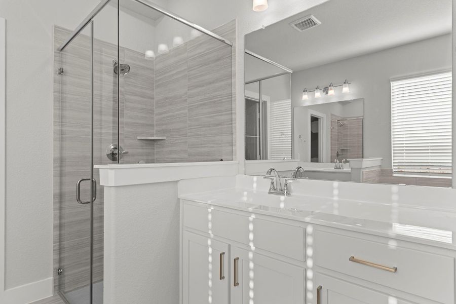 A closer look at the frameless glass shower showcases its modern style and spacious feel. Elegant tile details and a sleek layout add to the spa-like atmosphere of this tranquil retreat.