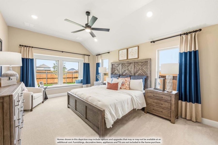 Spacious master bedroom with vaulted ceiling, ceiling fan, wood-framed bed, and blue curtains on multiple windows