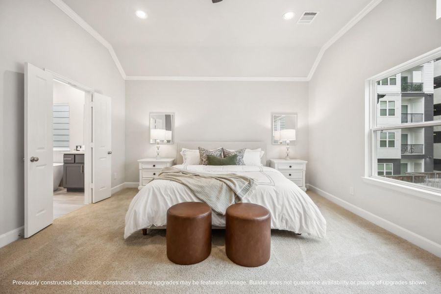 Your serene haven awaits. A vaulted ceiling and access to two closets and an en suite bathroom enhance the luxury of this spacious retreat.