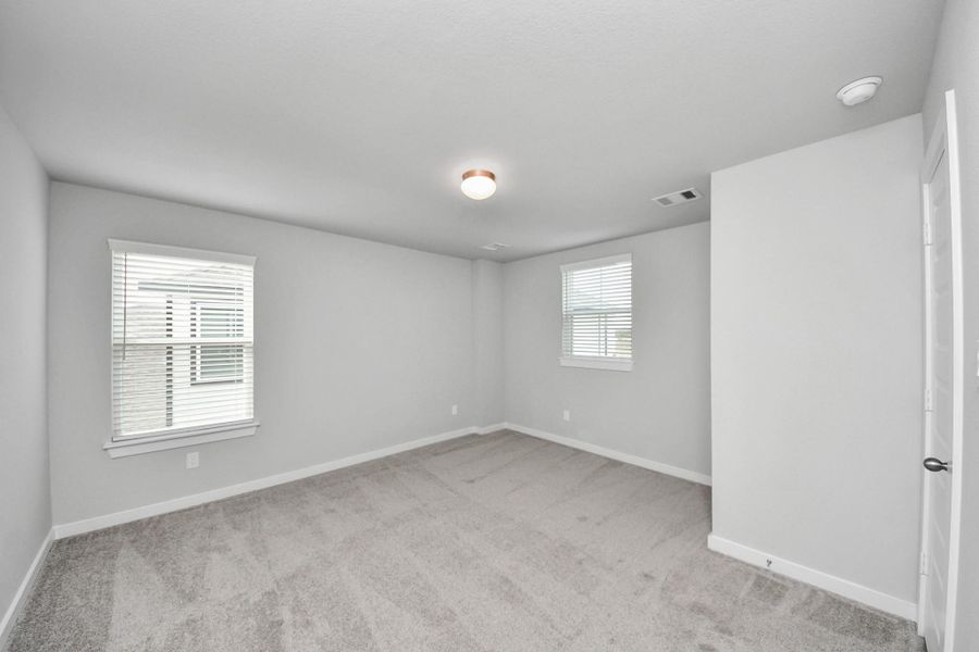 Secondary bedroom features plush carpeting, large windows that let in plenty of natural light, bright paint, and spacious closets. Secondary bedroom features plush carpeting, large windows that let in plenty of natural light, bright paint, and spacious closets.