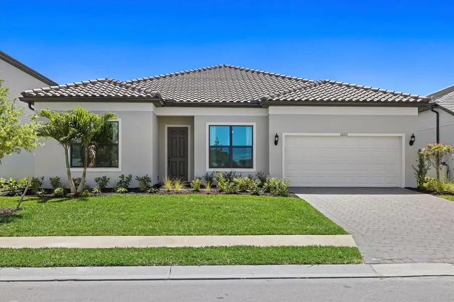 Front exterior of a new home in , Lakewood Ranch, FL, highlighting curb appeal (Image 2). Front exterior of a new home in , Lakewood Ranch, FL, highlighting curb appeal (Image 2).