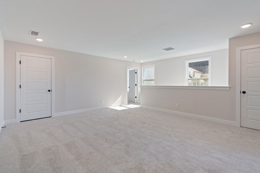 Empty room featuring light colored carpet and recessed lighting Empty room featuring light colored carpet and recessed lighting
