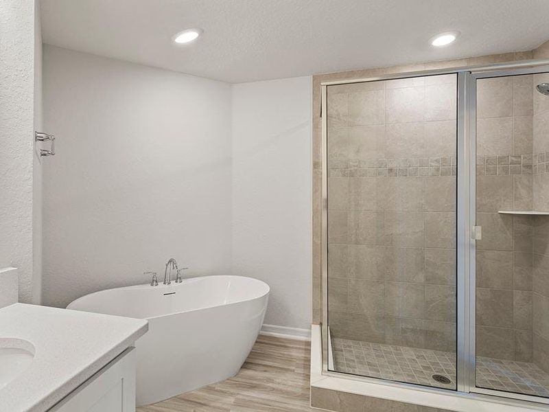 Your bath includes a tiled shower, freestanding tub, linen closet, and closeted toilet - Danyella bungalow by Highland Homes