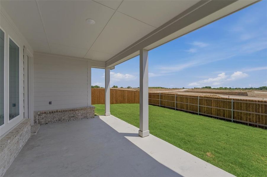 Covered patio featuring a concrete slab and painted support columns