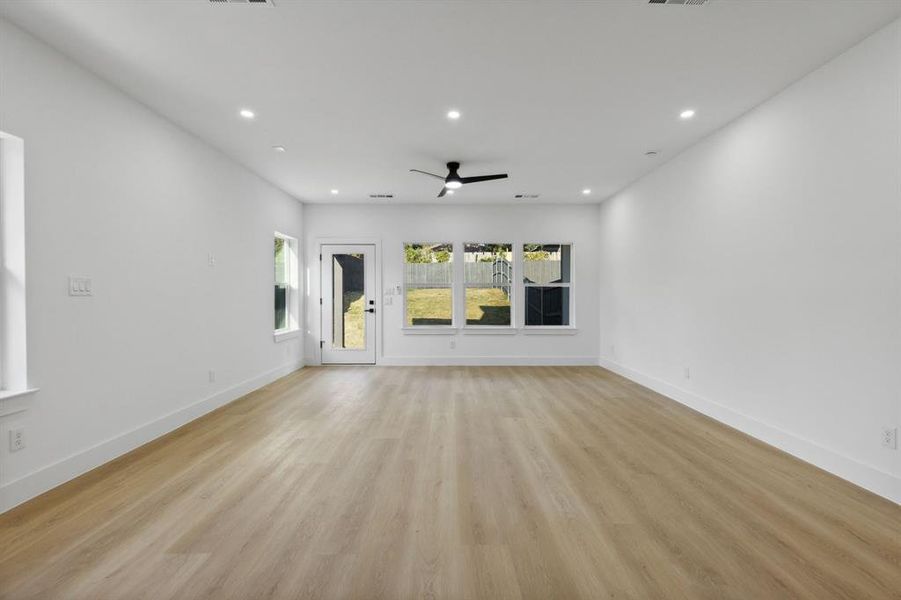 Unfurnished living room featuring light hardwood / wood-style floors and ceiling fan