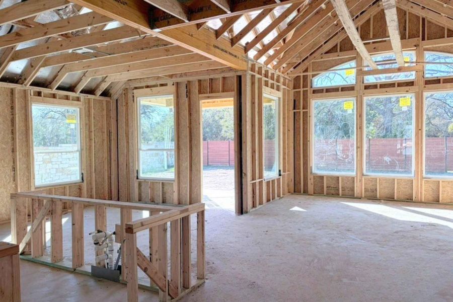 Unfurnished sunroom featuring healthy amount of natural light and vaulted ceiling