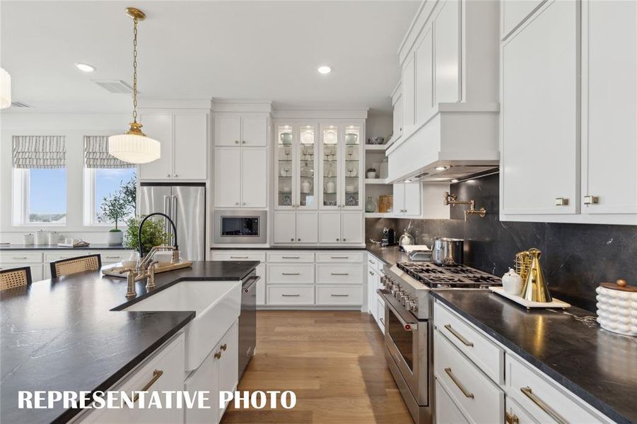 Gorgeous counter tops, beautiful cabinetry and lovely flooring paired with contemporary stainless steel all combine to create this timeless kitchen!  REPRESENTATIVE PHOTO