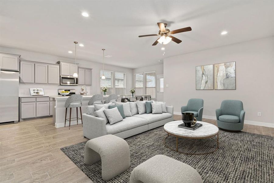 Living room featuring ceiling fan and light hardwood / wood-style flooring