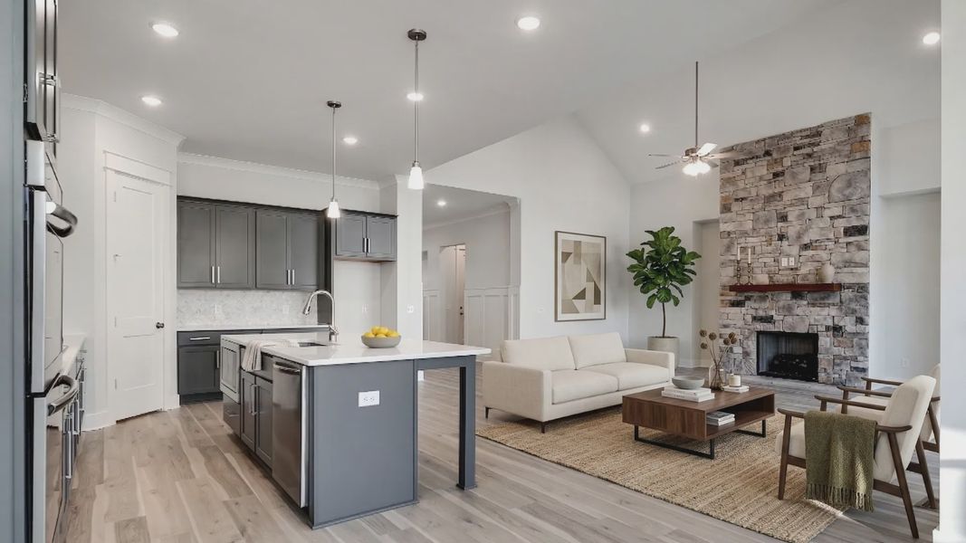 Virtually staged living room with stone fireplace near kitchen Virtually staged living room with stone fireplace near kitchen