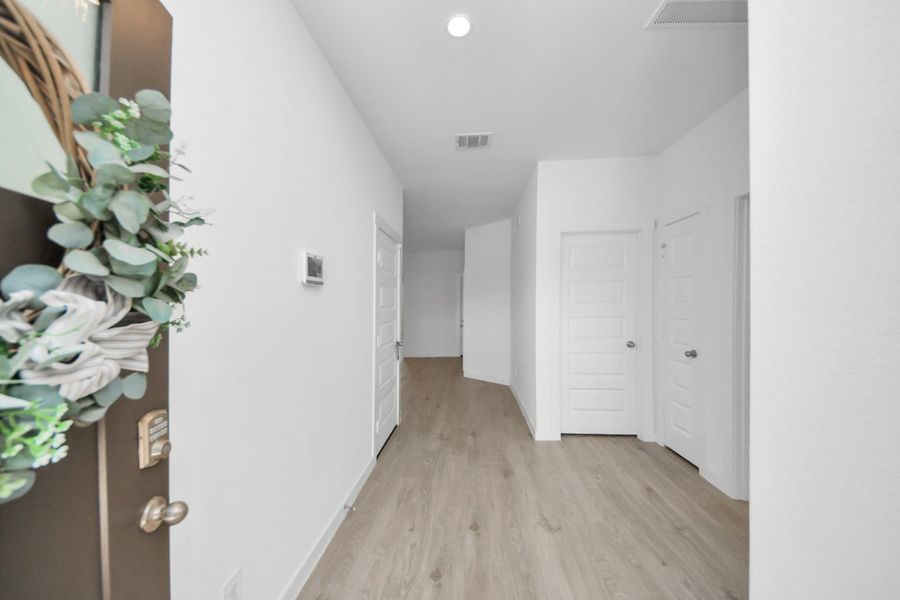 Long entry way gives way to an open livingroom and kitchen.