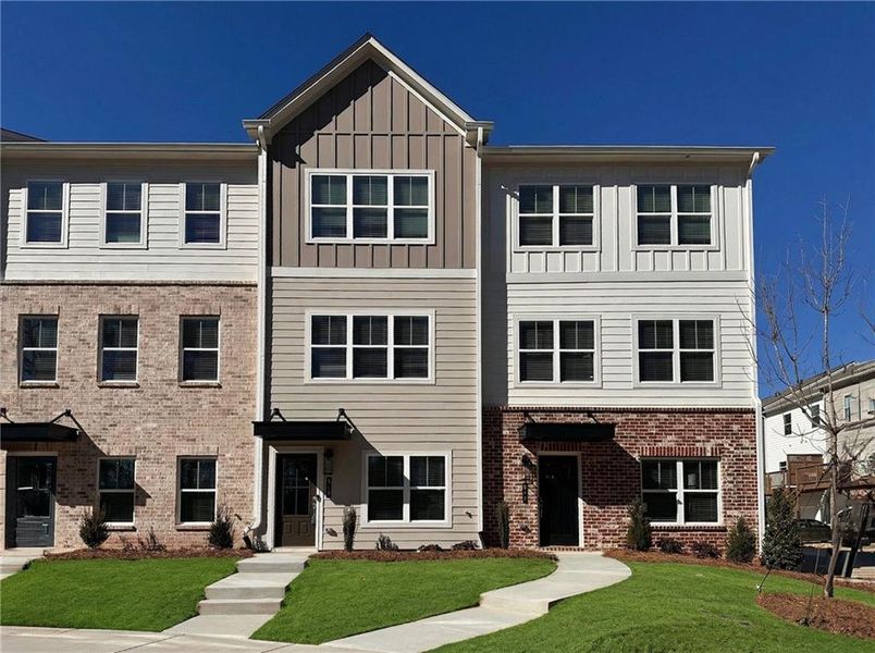 Front exterior of a new home in Magnolia Grove, Mableton, GA, highlighting curb appeal (Image 1). Front exterior of a new home in Magnolia Grove, Mableton, GA, highlighting curb appeal (Image 1).