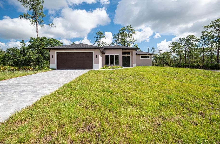 Front exterior of a new home in , Lehigh Acres, FL, highlighting curb appeal (Image 23).