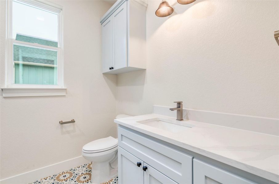 Bathroom featuring vanity, plenty of natural light, and tile patterned floors
