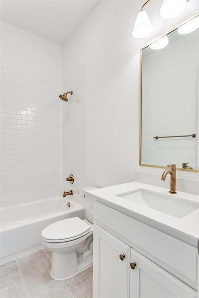 Full bathroom with shower / washtub combination, vanity, and light tile patterned floors Full bathroom with shower / washtub combination, vanity, and light tile patterned floors