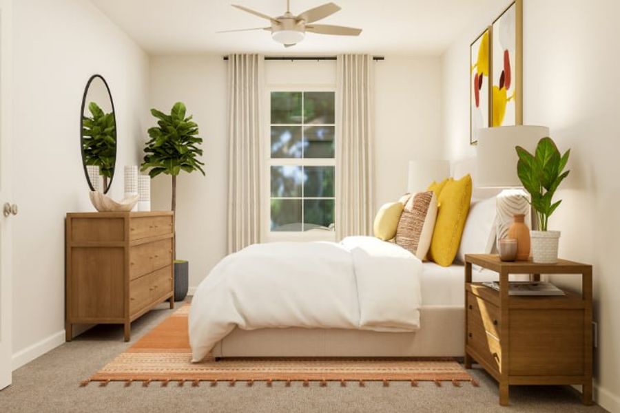 A living room with a white couch and a fan.