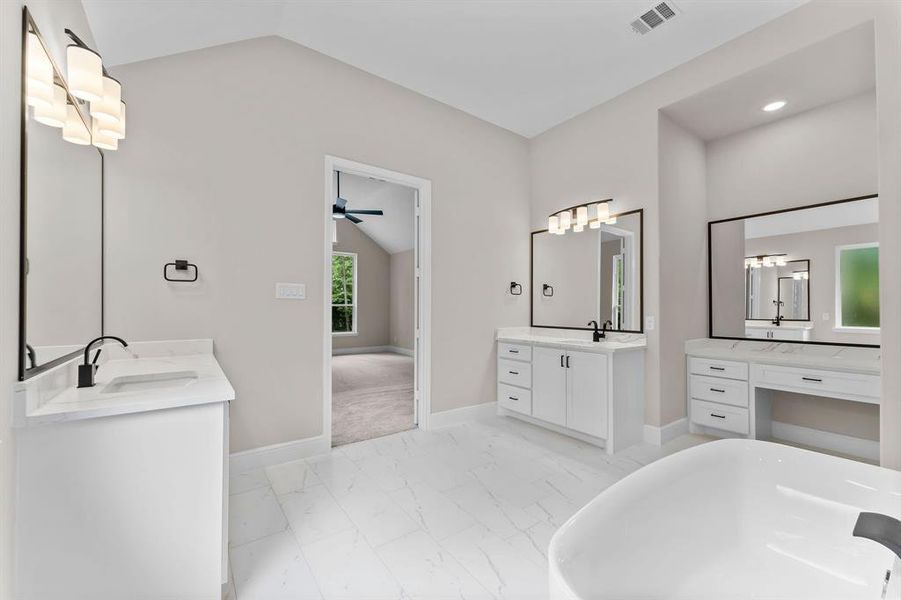 Primary bath with separate sinks, vanity and freestanding tub