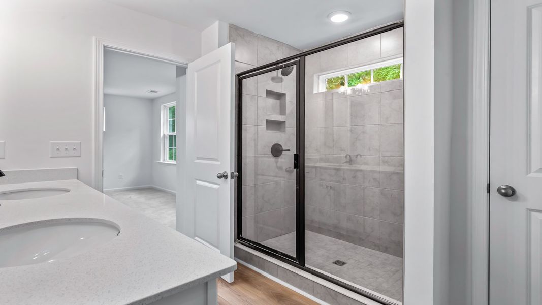 Refresh in the sleek glass shower of the Pritchard’s primary bath