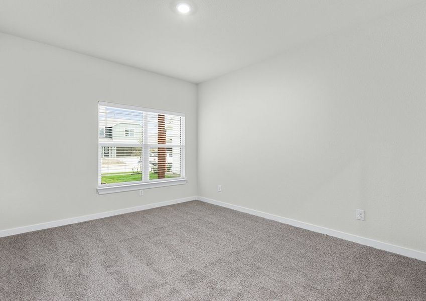 The master bedroom is spacious and has a large window.