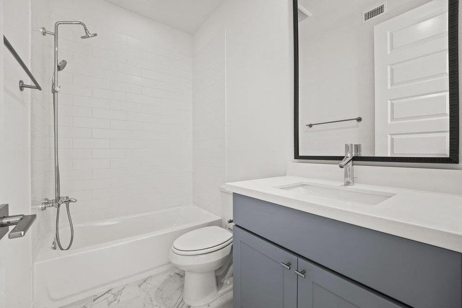 Main floor full bathroom with tub/shower combo with a hand held sprayer.