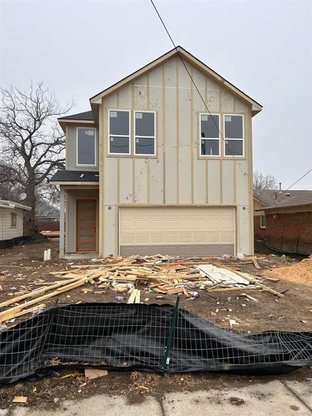 View of front of property featuring a garage