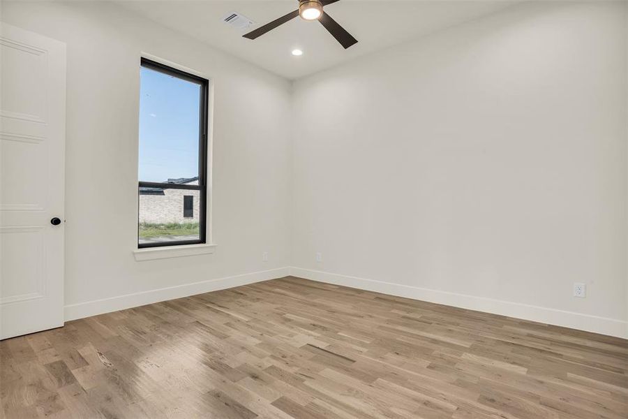 Empty room featuring light wood finished floors, recessed lighting, and a ceiling fan