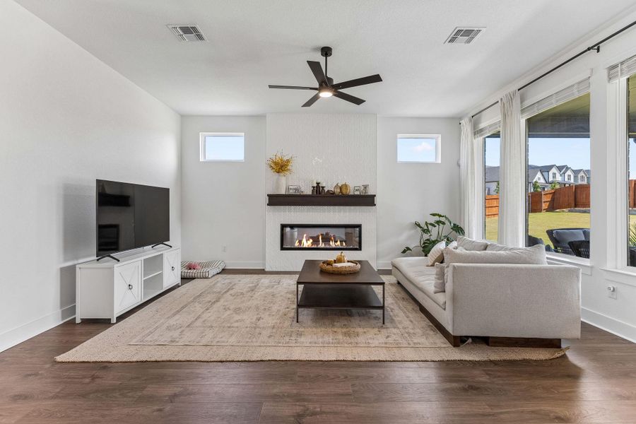 Rich wood flooring anchors this comfortable living area anchored by a modern linear fireplace.