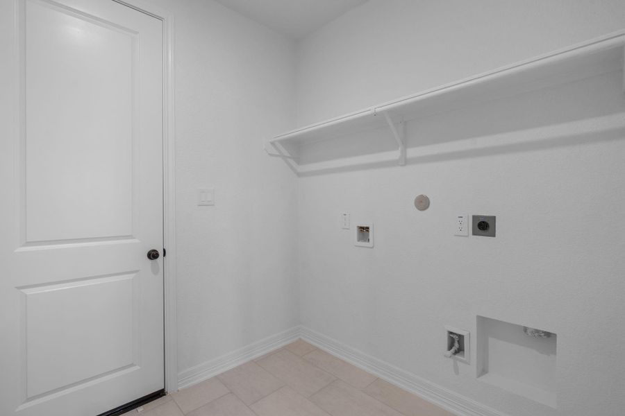 The laundry room layout is carefully planned for optimal workflow with designated areas for washing, drying, and storing.