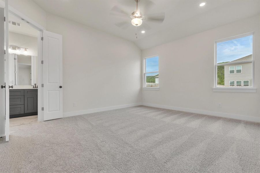 Bright and airy, this bedroom provides a tranquil retreat with plush carpet flooring and ample natural light.
