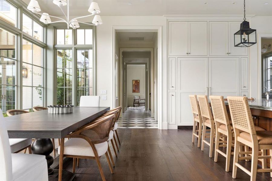 Dining room with a chandelier and dark wood-type flooring Dining room with a chandelier and dark wood-type flooring