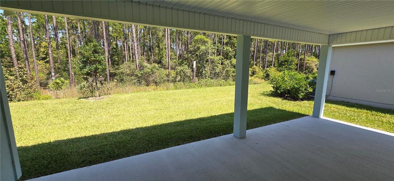 Exterior details and patio area of a home in Sawmill Branch Express, Palm Coast (Image 2).