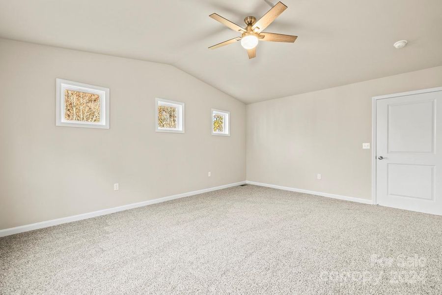 Large primary bedroom with added windows to enhance the natural light