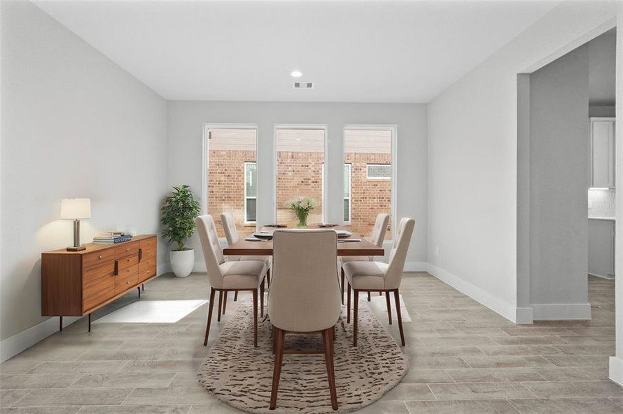 Make memories gathered around the table with your family and friends! This dining room features high ceilings, custom paint, recessed lighting, and large windows with privacy blinds.