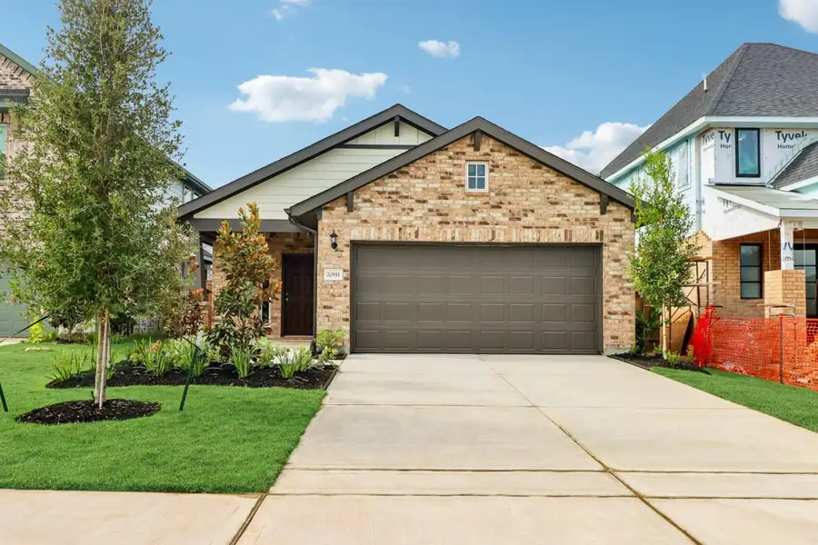 Front exterior of a new home in Sorella, Tomball, TX, highlighting curb appeal (Image 1). Front exterior of a new home in Sorella, Tomball, TX, highlighting curb appeal (Image 1).