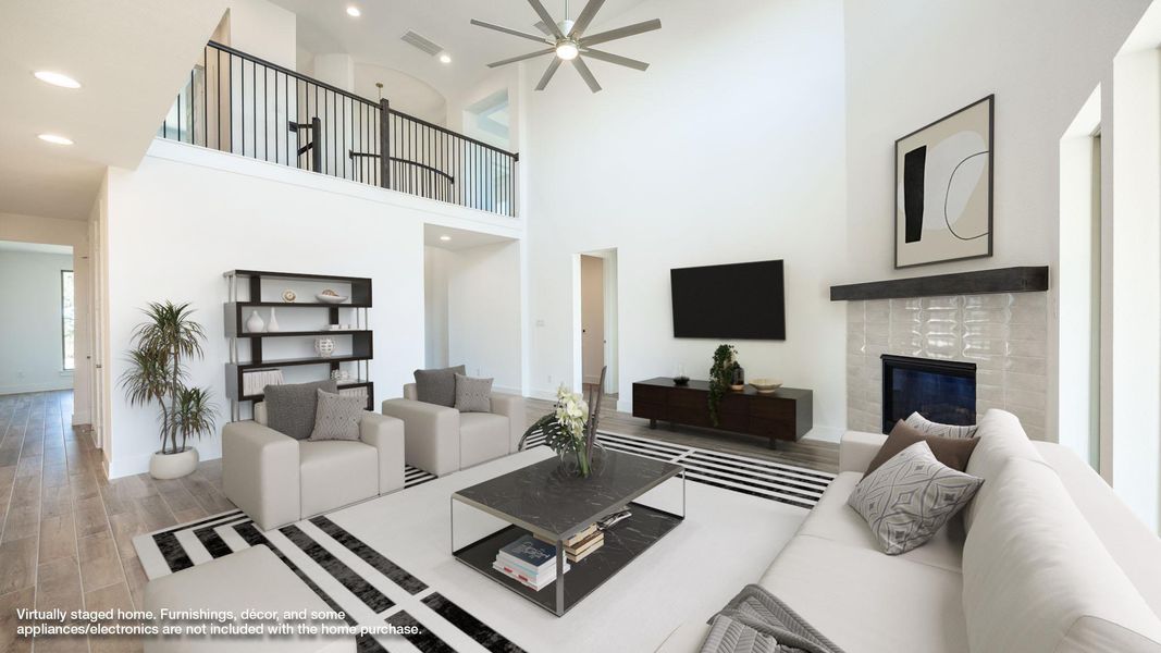 Living room with light wood-style flooring, a fireplace, recessed lighting, a high ceiling, and ceiling fan Living room with light wood-style flooring, a fireplace, recessed lighting, a high ceiling, and ceiling fan