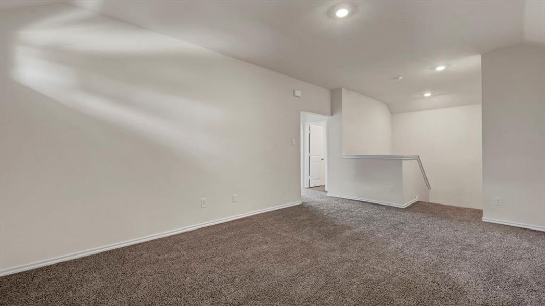 Carpeted room featuring light-colored walls and recessed ceiling lighting