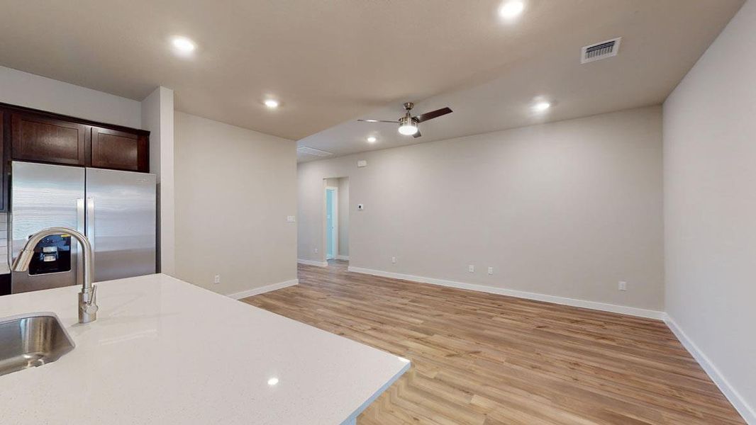 The open-concept layout features rich hardwood flooring leading to a sleek kitchen with a spacious island. The open-concept layout features rich hardwood flooring leading to a sleek kitchen with a spacious island.