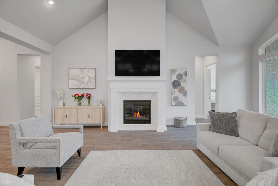 The impressive 19' x 25' living room offers dramatic 15' cathedral ceilings and a beautiful gas-log fireplace, providing the perfect setting for cozy winter nights and comfortable year-round living.