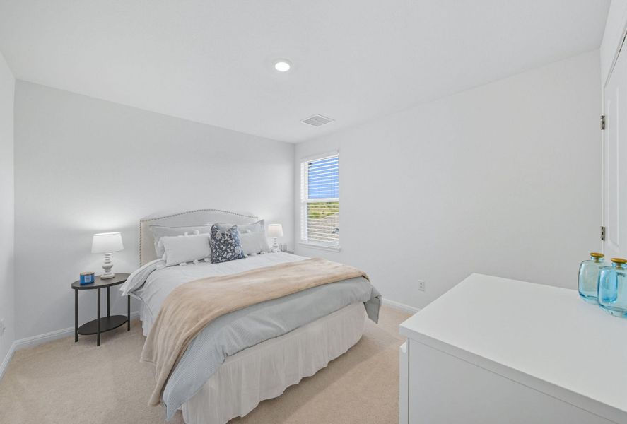 Bedroom with light carpet and baseboards Bedroom with light carpet and baseboards