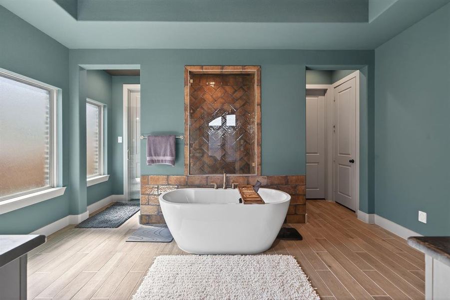 Spa-inspired bath with freestanding tub and dual granite vanities. Spa-inspired bath with freestanding tub and dual granite vanities.