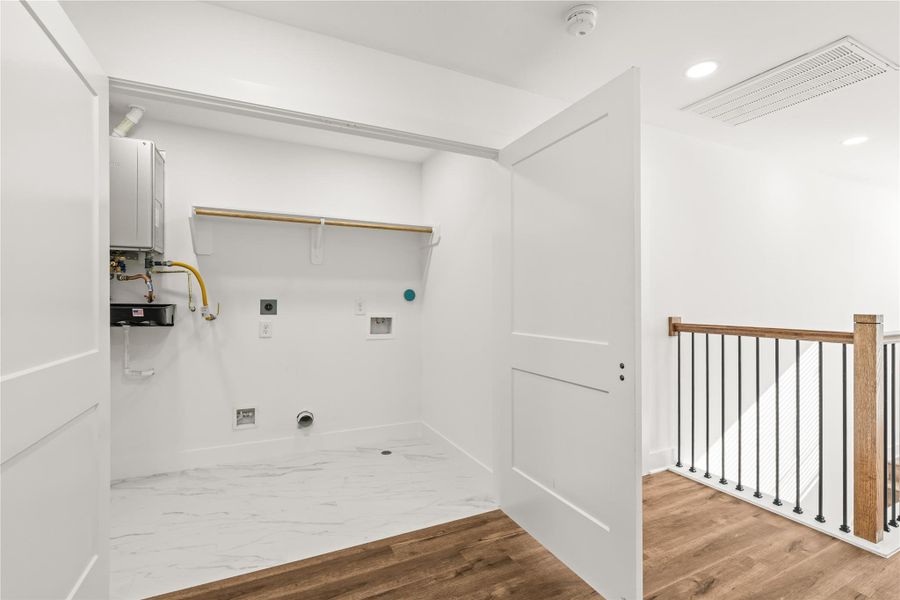 Efficiency at its finest. No more carrying heavy baskets up and down the stairs—this upper-level laundry zone puts chore day right where the bedrooms are.
