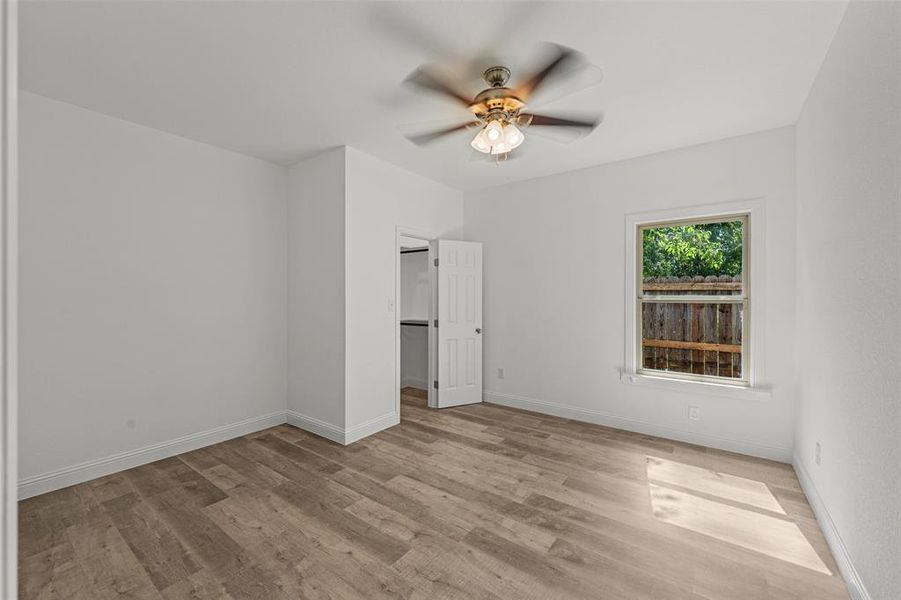 Spare room with light wood-type flooring and ceiling fan