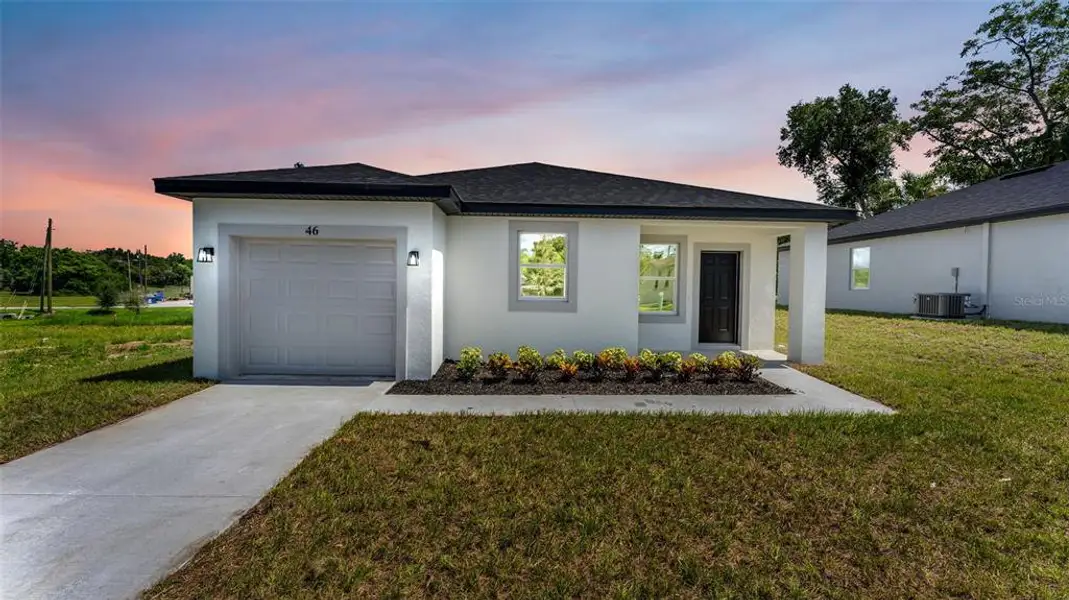 Front exterior of a new home in , Haines City, FL, highlighting curb appeal (Image 18). Front exterior of a new home in , Haines City, FL, highlighting curb appeal (Image 18).