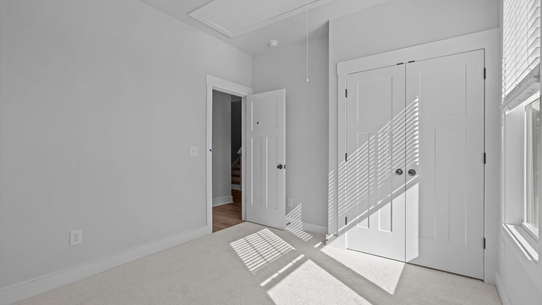 First-class secondary bedroom with comfortable carpeted flooring and generous closet space