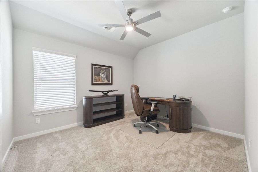 Inviting home office with ample natural light, neutral carpet, and minimalist decor. Inviting home office with ample natural light, neutral carpet, and minimalist decor.