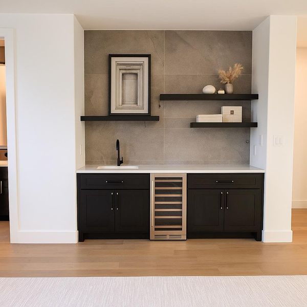 The game room boasts a custom wet bar with a sink and space for a beverage fridge.