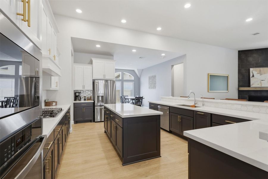 Modern kitchen featuring an abundance of cabinetry, stainless steel appliances, and a large island with Quartz countertops, perfect for culinary enthusiasts and entertaining. Modern kitchen featuring an abundance of cabinetry, stainless steel appliances, and a large island with Quartz countertops, perfect for culinary enthusiasts and entertaining.