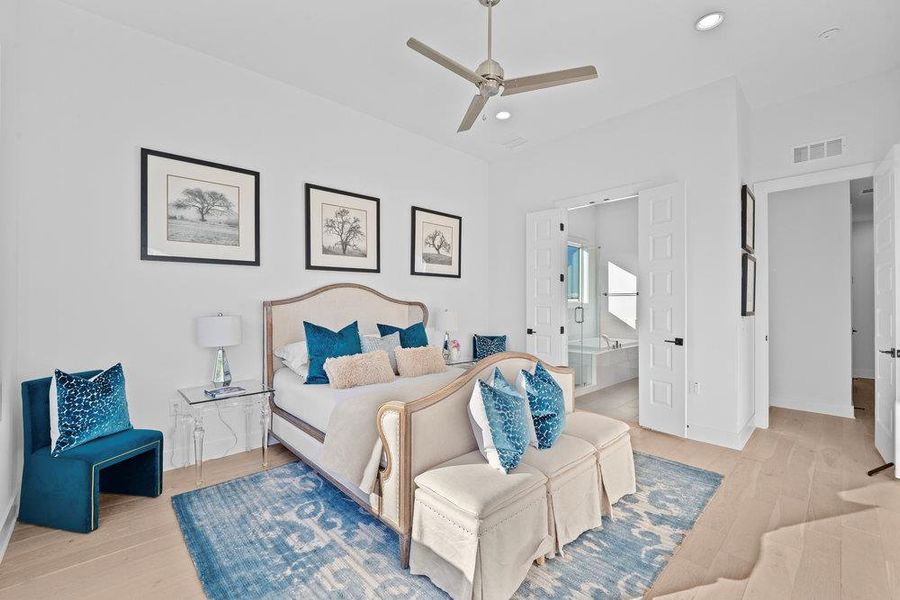 Bedroom featuring light wood finished floors, recessed lighting, ceiling fan, and ensuite bath