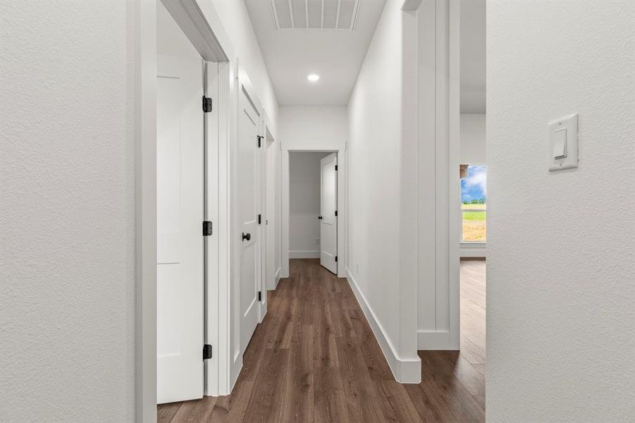 Hallway with dark wood-style floors and recessed lighting