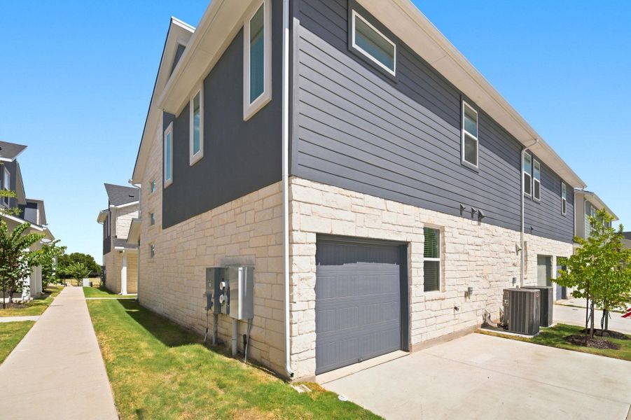 Modern exterior design showcases a blend of light-colored stone and dark siding on this contemporary multi-level home.